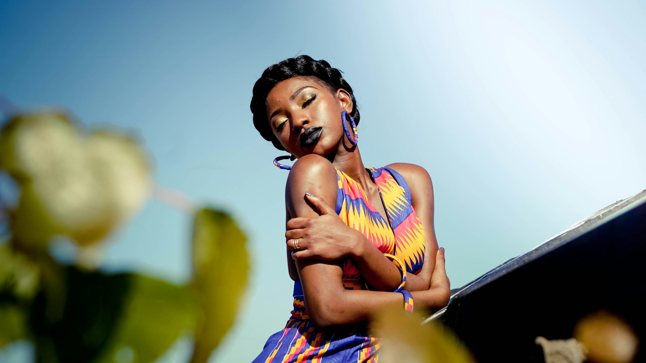 Lady wearing colourful dress hugging herself